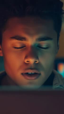 Hispanic man rubbing eyes while staring at laptop screen late-night, showing fatigue