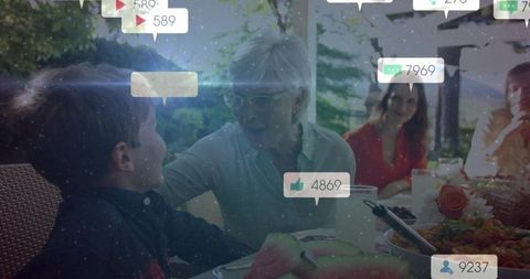 Family enjoying outdoor meal with social media interaction