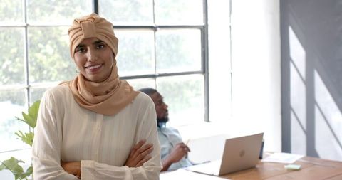 Confident Woman in Hijab Standing in Modern Office