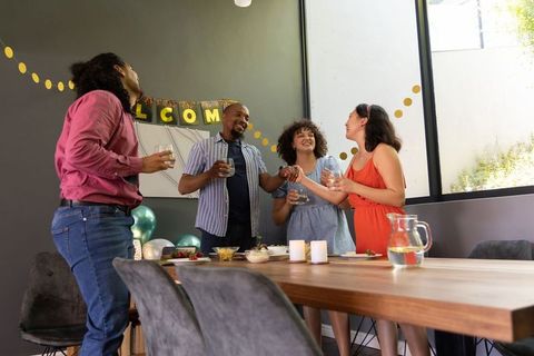Diverse Friends Celebrating Host Welcome Party Indoors