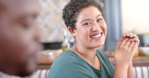 Woman smiling with friends during home gathering