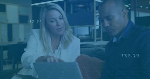 Colleagues Collaborating in Office Lounge with Data Graphics Overlay