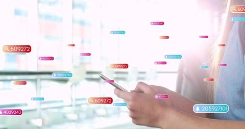 Woman tapping smartphone amid floating notification tags in sunlit minimalist lounge