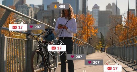 Woman checking phone on city bridge with bicycle and social media notifications, autumn