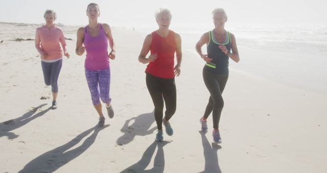 Group of women enjoying a run on the beach during sunset, representing an active and healthy lifestyle. Perfect for fitness, wellness campaigns, vacation promotions, outdoor activity features, or health and well-being articles.