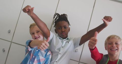 Happy Diverse Kids Giving Thumbs Up in School Setting