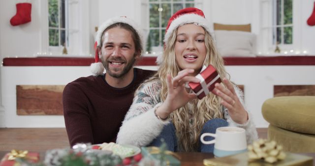 Happy Couple With Christmas Gift in Cozy Living Room - Download Free Stock Images Pikwizard.com