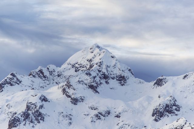 Snow-covered Mountain Peak Against Cloudy Sky - Download Free Stock Photos Pikwizard.com