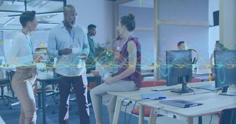 Collaborating team in modern open-plan office sharing ideas with digital waveform overlay