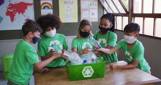 Happy diverse children in facemasks, learning to recycle in school class. School, learning, childhood, recycling, ecology and education, unaltered, health, hygiene, coronavirus.