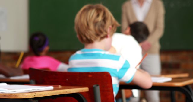 Students Writing in Classroom with Teacher in Background - Download Free Stock Images Pikwizard.com