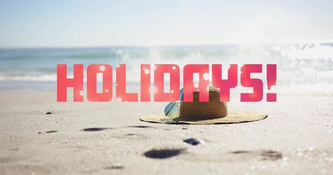 Holidays concept with straw hat and sunglasses on beach