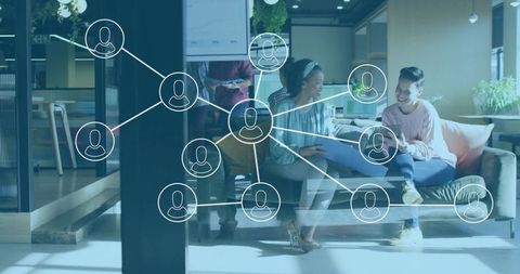 Young professionals collaborating in modern coworking lounge with digital network overlay