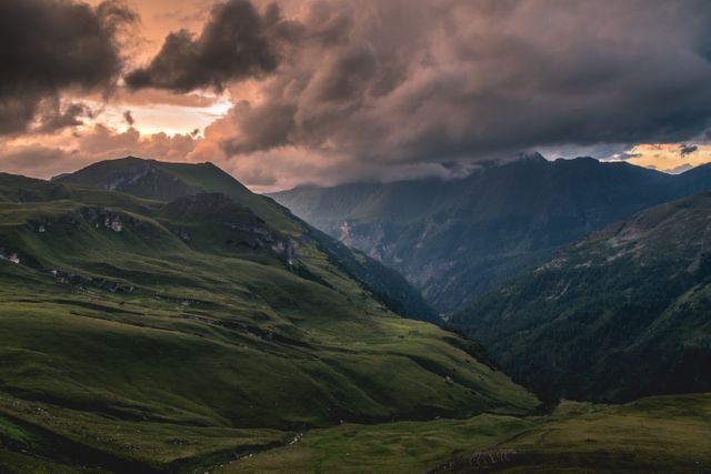 Ideal for use in travel brochures, scenic posters, environmental campaigns, and outdoor adventure blogs. Captures the breathtaking and moody atmosphere of a mountainous region under stormy clouds during sunset.