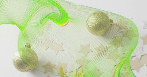 Flowing lime-green mesh ribbon with gold glitter baubles and star confetti minimal holiday decor