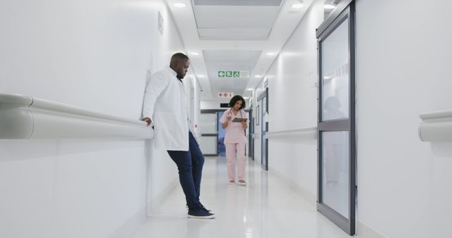 Healthcare Professionals Conversing in Hospital Corridor - Download Free Stock Images Pikwizard.com