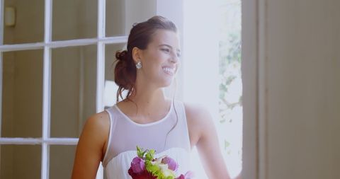 Bride Smiling by Sunlit Window Holding Bouquet - Download Free Stock Images Pikwizard.com
