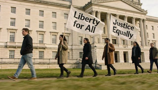 Marching protesters holding liberty for all and justice equally banners by neoclassical courthouse