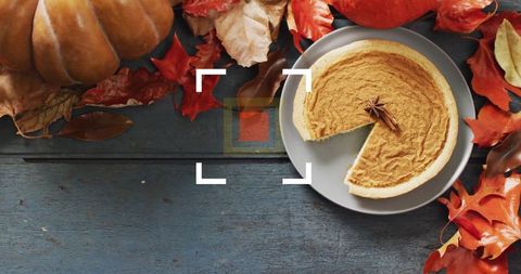 Pumpkin Pie on Rustic Table Amidst Autumnal Decor