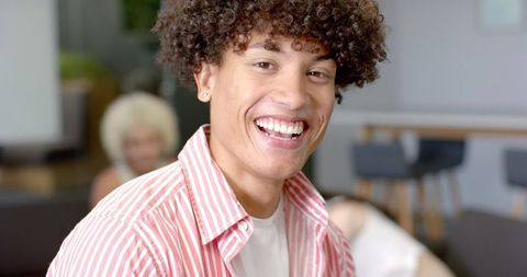 Smiling young man socializing indoors
