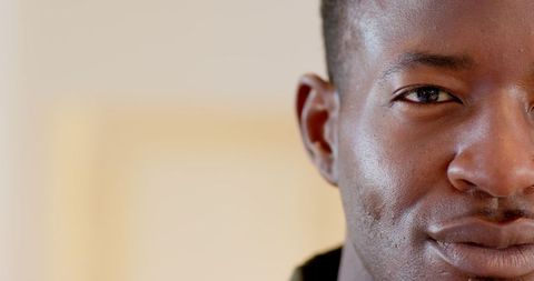 Close-up of contemplative man against a soft beige background