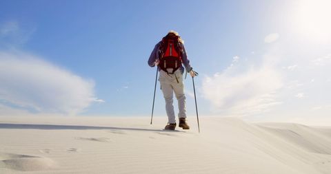 Hiker Adventuring on Desert Sand Dunes under Clear Sky