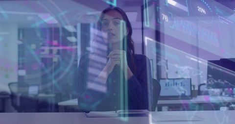 Businesswoman analyzing augmented reality data dashboards at modern office desk