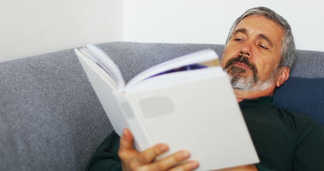 Senior Man Reading Book on Couch - Download Free Stock Images Pikwizard.com