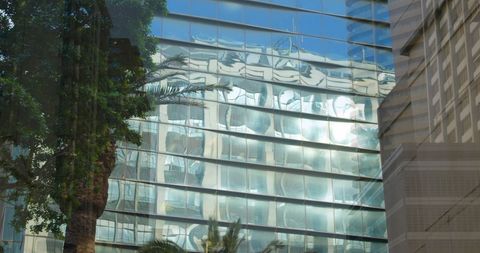 Reflective Glass Towers Merging with Natural Elements - Download Free Stock Images Pikwizard.com