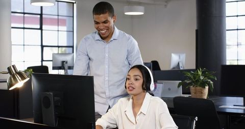 Diverse colleagues collaborating and communicating in modern office
