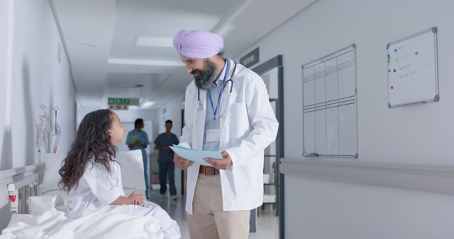 Doctor Interacting With Young Patient in Hospital Corridor - Download Free Stock Images Pikwizard.com