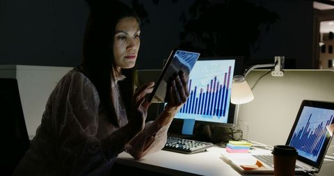 focused businesswoman analyzing data on digital tablet at night - Download Free Stock Images Pikwizard.com