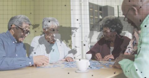 Seniors Solving Jigsaw Puzzle Together at Community Table with Dotted World Map Overlay