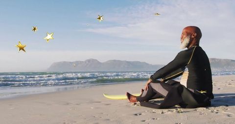 Contemplative surfer in wetsuit on beach with enhancing star graphics