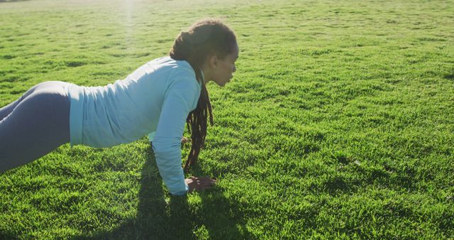 Young Woman Exercising Outdoors in Yoga Pose on Green Lawn - Download Free Stock Images Pikwizard.com