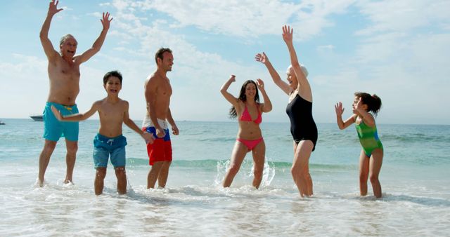 Multigenerational family enjoying vacation at the beach, playing in the ocean waves, everyone smiling and having fun. Ideal for travel websites, family vacation promotions, and advertisements for beach resorts or summer activities.