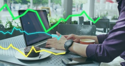 Businessman analyzing data with laptop in coffee shop setting