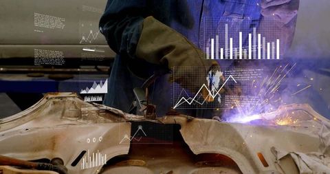 Welder cutting automotive chassis with torch and sparks, augmented reality data overlays