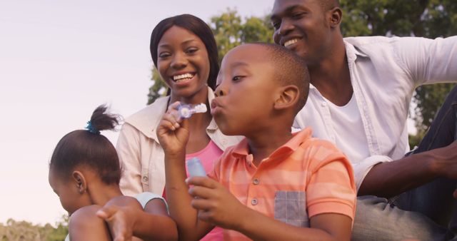 Happy Family Blowing Bubbles in Park on Sunny Day - Download Free Stock Images Pikwizard.com