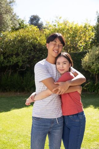 Happy Couple Embracing Outdoors in Sunny Private Garden