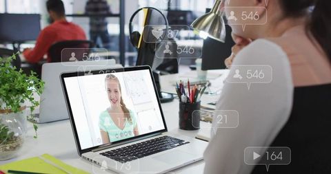 Collaborating on remote video call in modern open-plan office workspace