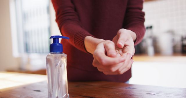 Close-up of Person Using Hand Sanitizer in Kitchen - Download Free Stock Images Pikwizard.com