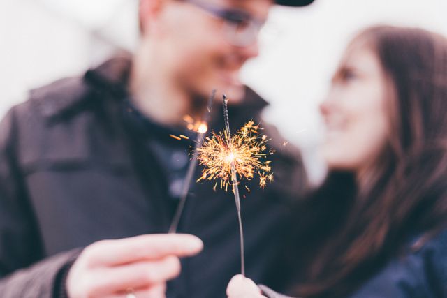 Couple Celebrating with Sparklers Blurry Background - Download Free Stock Images Pikwizard.com