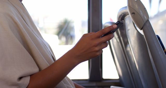 Person holding smartphone while sitting on public bus - Download Free Stock Images Pikwizard.com