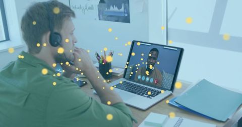 Caucasian man on video call with bitcoin icons overlay