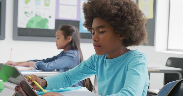 African-American boy writing in classroom, focus on schoolwork - Download Free Stock Images Pikwizard.com