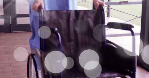 Blurred Spots Overlaying Empty Wheelchair in Hospital Corridor - Download Free Stock Images Pikwizard.com