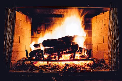 Brick Fireplace with Burning Logs and Glowing Flames