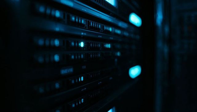Glowing black server rack humming with blue leds showing drive bays and network hardware