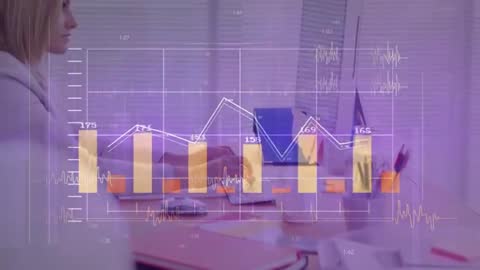 Woman Typing at Desk with Animated Finance Graphs Display